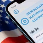 Smartphone screen showing Democratic National Committee website above flag.