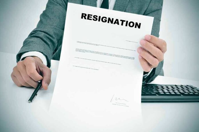 235530895 featured image Person holding resignation letter at desk