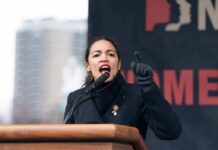 AOC speaking passionately at podium outdoors