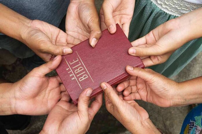 133452947 featured image Hands holding a closed red Bible together