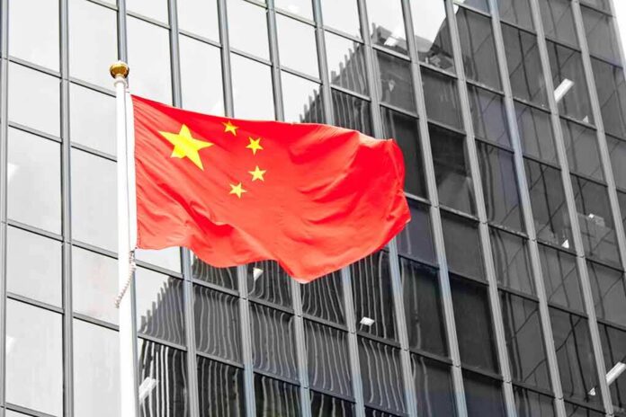141608113 featured image Red flag with yellow stars on building background