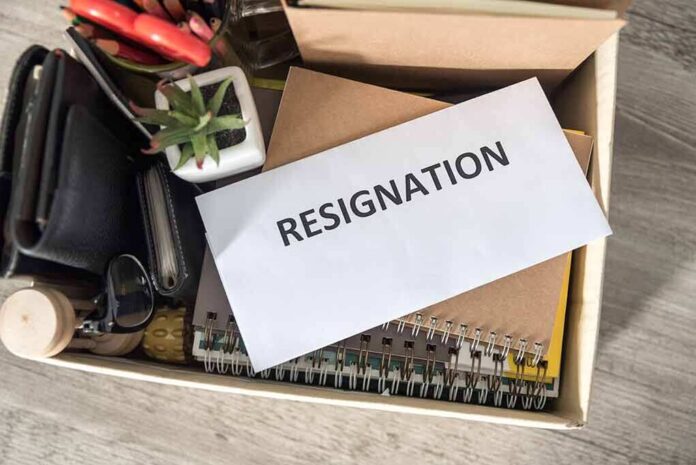 1487893499 featured image Envelope labeled "RESIGNATION" atop office supplies in box.