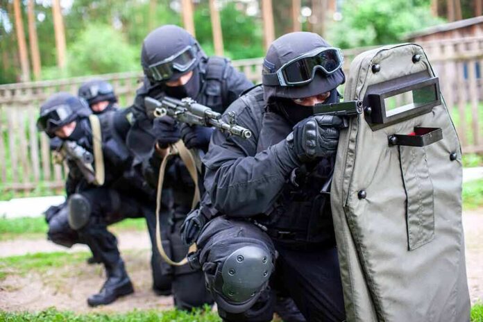 1841092291 featured image SWAT team members aiming rifles behind a protective shield