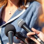 Person with microphones and smartphone during interview