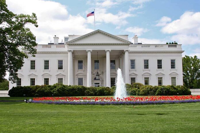 71114719 featured image White building with fountain and flower garden front