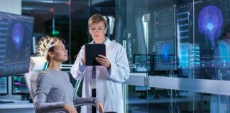 Woman undergoing brain scan with doctor monitoring results