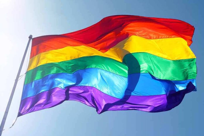 115334458 featured image Rainbow flag waving against clear blue sky