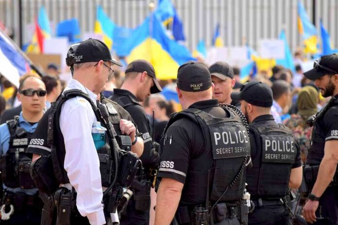 2132863557 featured image Police officers gathered near a crowd with flags