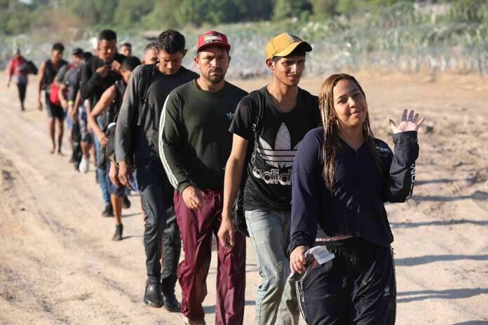 2364873693 featured image Line of people walking on a dirt road.