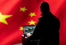 Person using laptop with Chinese flag background