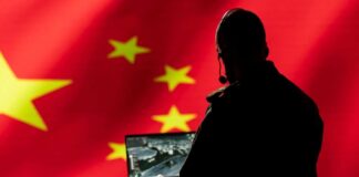 Person using laptop with Chinese flag background