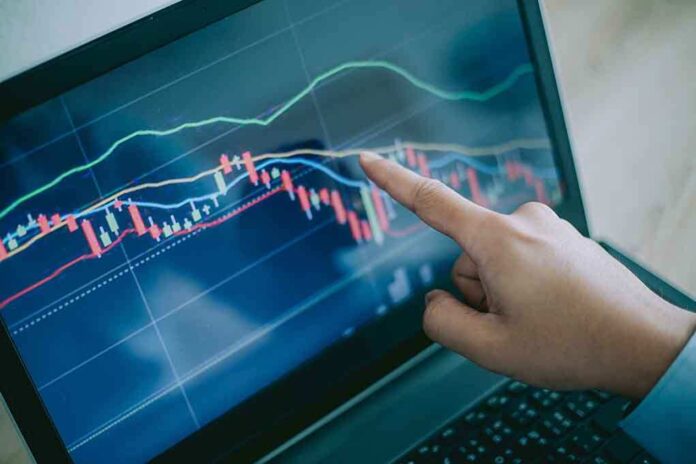 114313067 featured image Hand pointing at graph on laptop screen