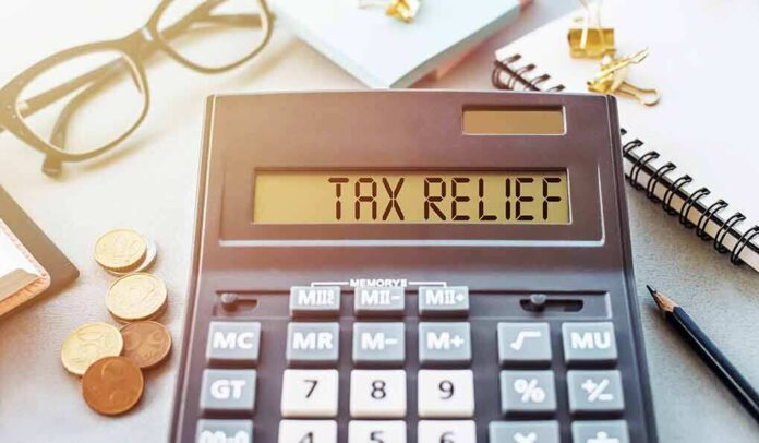 1908079453 featured image Calculator display reads TAX RELIEF amidst coins and glasses