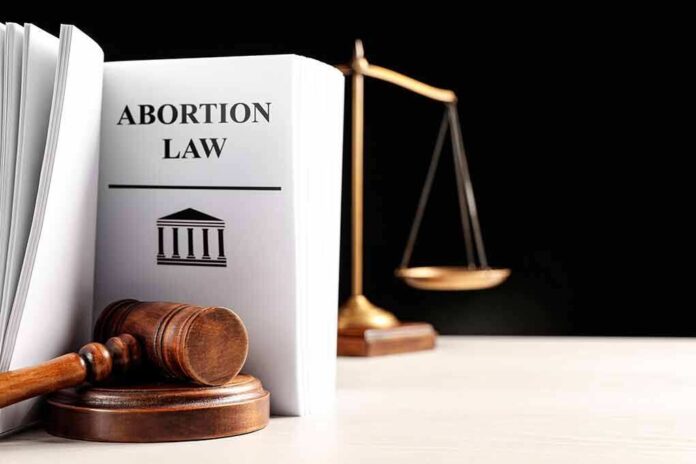 2250880469 featured image Gavel and abortion law book next to scales