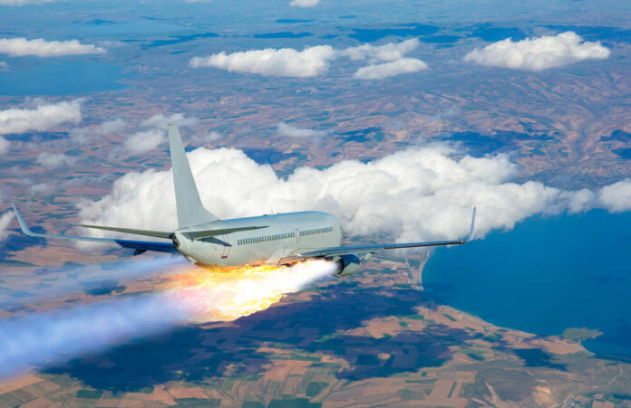 Passenger airplane with rocket engine flying over countryside