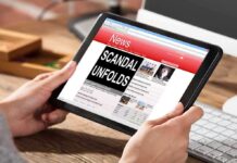 Person reading news headline Scandal Unfolds on table