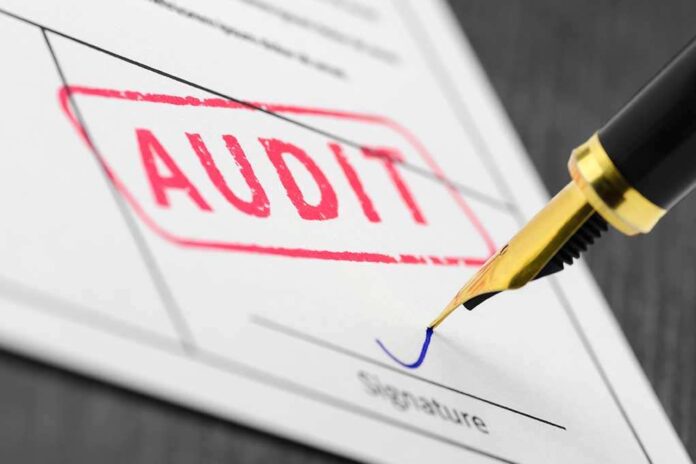 655581304 featured image Audit stamp and pen signing a document