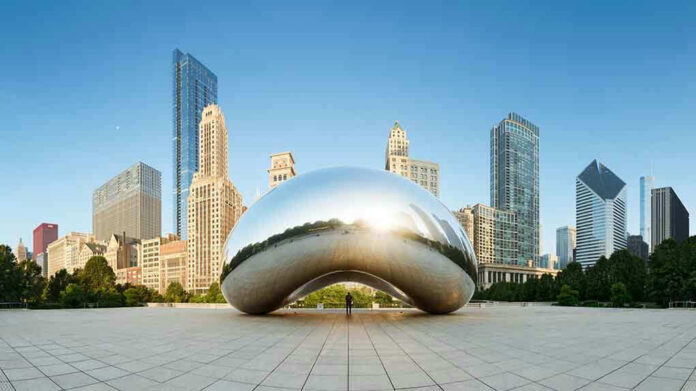 1075027280 Cloud Gate sculpture with skyline of skyscrapers behind it