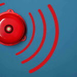Red alarm bell on a blue background