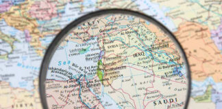 Magnifying glass over Middle East map highlighting Israel and Egypt