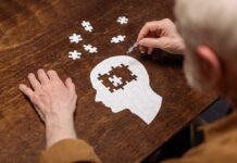 Elderly person completing head shaped jigsaw puzzle
