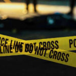 Police tape marking a crime scene at night