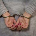 Person in handcuffs with gray sweater