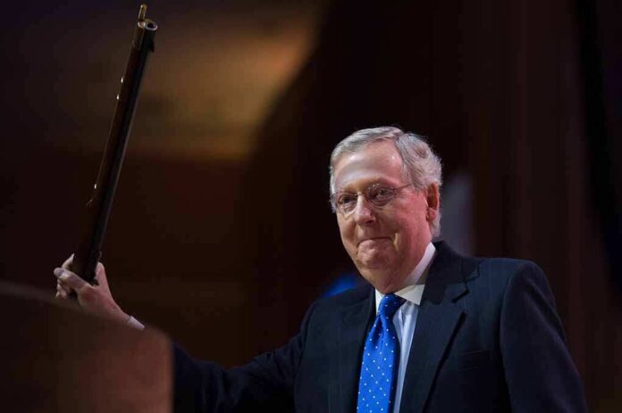A political figure smiling while holding a microphone