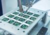 Close up of a soldering machine working on circuit boards