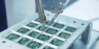 Close up of a soldering machine working on circuit boards