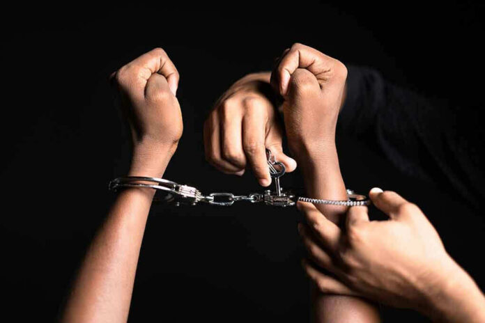 Handling handcuffs and unlocking with a key.