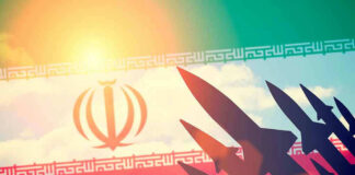 Silhouettes of missiles over Iran's flag graphic