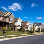 A row of modern suburban houses under a clear blue sky