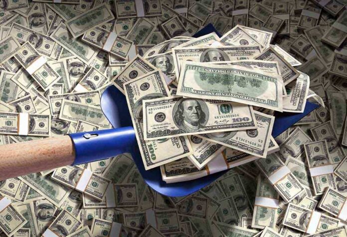A shovel filled with stacks of cash on a background of scattered dollar bills