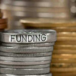 Stack of coins labeled funding with other coins stacks