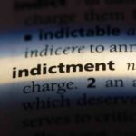 Close-up of a dictionary page showing the definition of indictment