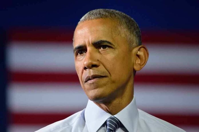 Close-up of a serious-looking man in front of an American flag