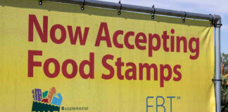 Yellow sign now accepting food stamps EBT SNAP