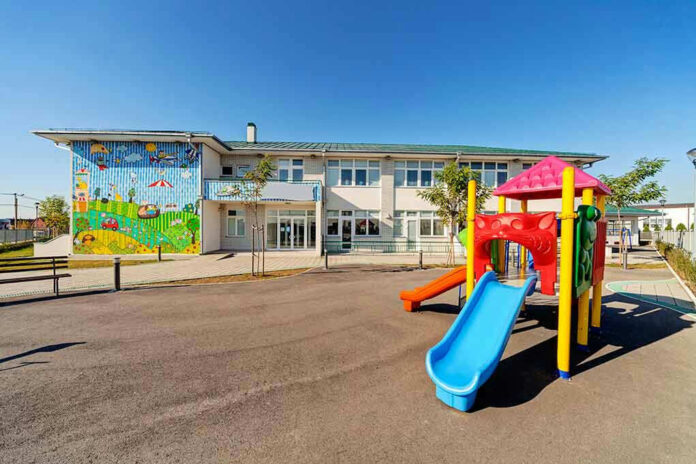 Colorful playground slide in front of a building.