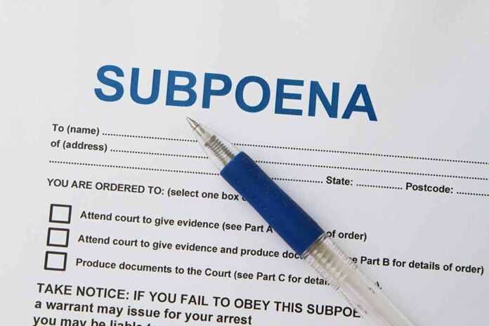 A subpoena document with a blue pen resting on it