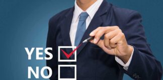 Business professional indicating a yes choice with a pen