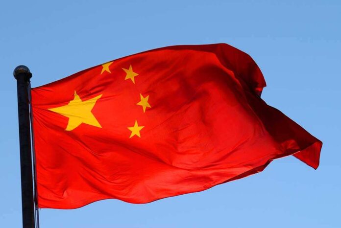 Chinese flag waving against a clear blue sky
