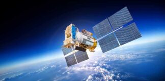 A satellite equipped with solar panels orbiting above the Earth