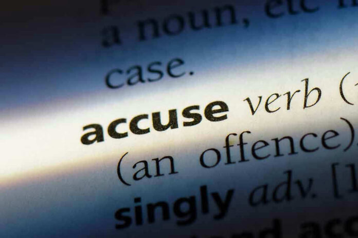 Close-up dictionary definition of accuse underlined.
