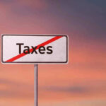 Sign with the word Taxes crossed out.