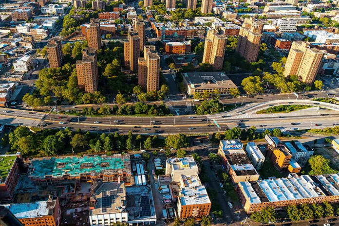 Aerial view of urban area with tall buildings and freeway.