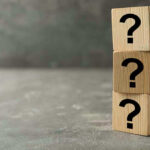 Putin’s Ally SUDDENLY Drops Dead—Mystery DEEPENS Three wooden blocks with black question marks stacked.
