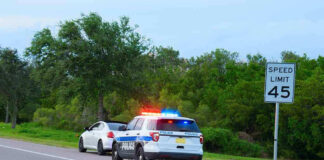 Police car pulling over a white car