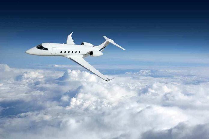 Private jet flying above the clouds.