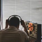 EXPOSED — Britain’s Own Spy Ran IRA Torture Ring Person wearing headphones listening to a reel-to-reel tape recorder